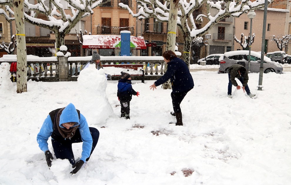 Una família jugant amb la neu, ahir, a la plaça Capdevila de Tremp