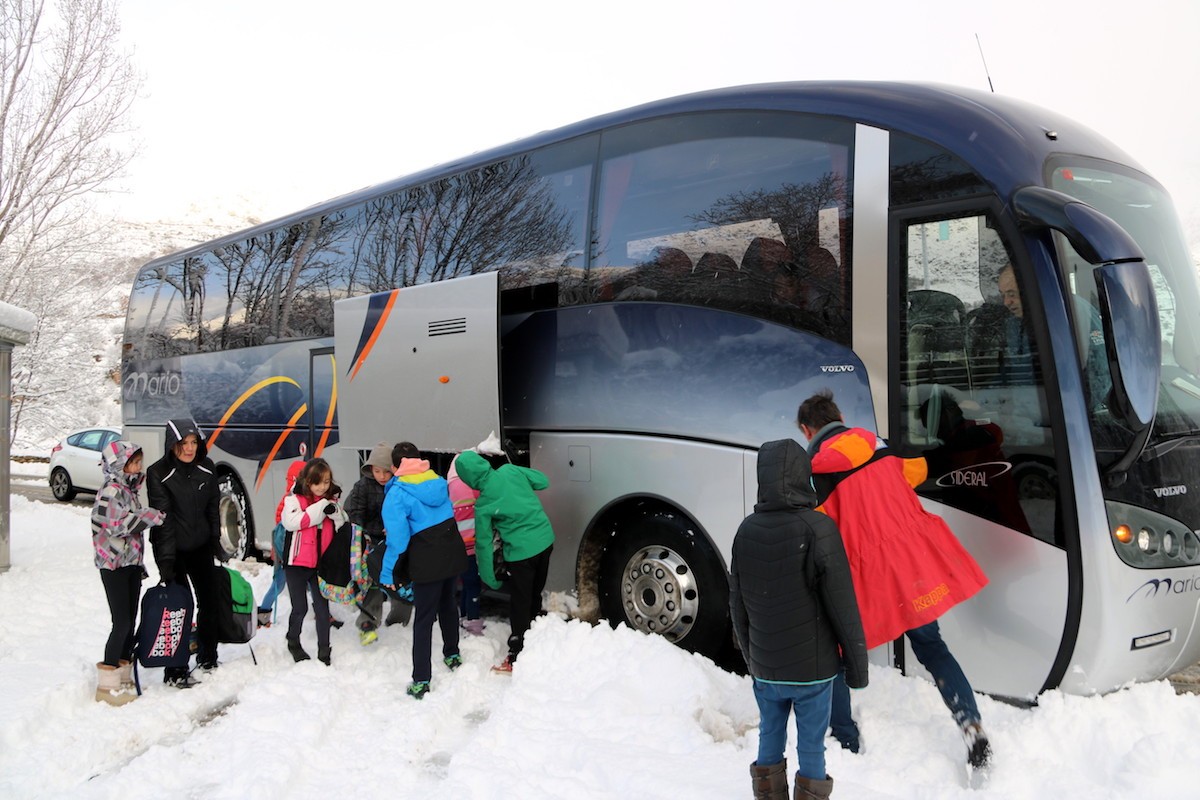 Infants pujant al transport escolar en una localitat del Pallars Sobirà