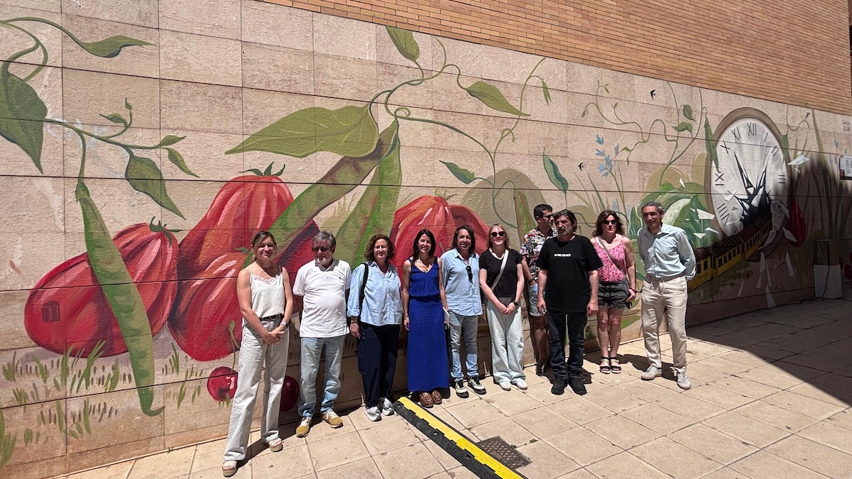 Fotografia de família davant el mural de Swen Schmitz Coll a la plaça Domènec Cardenyes